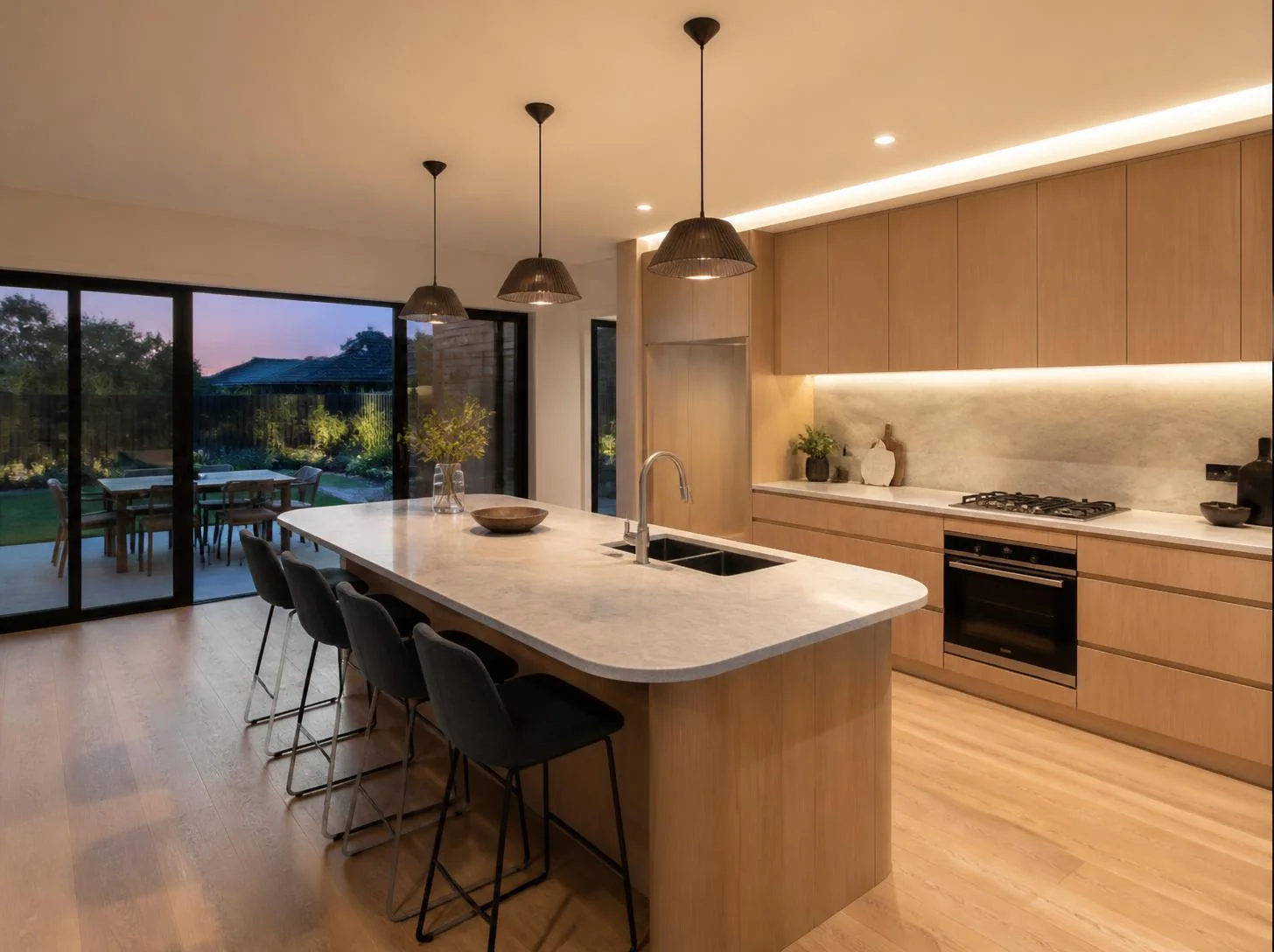 Finished kitchen renovation with clean cabinetry and bright benchtops